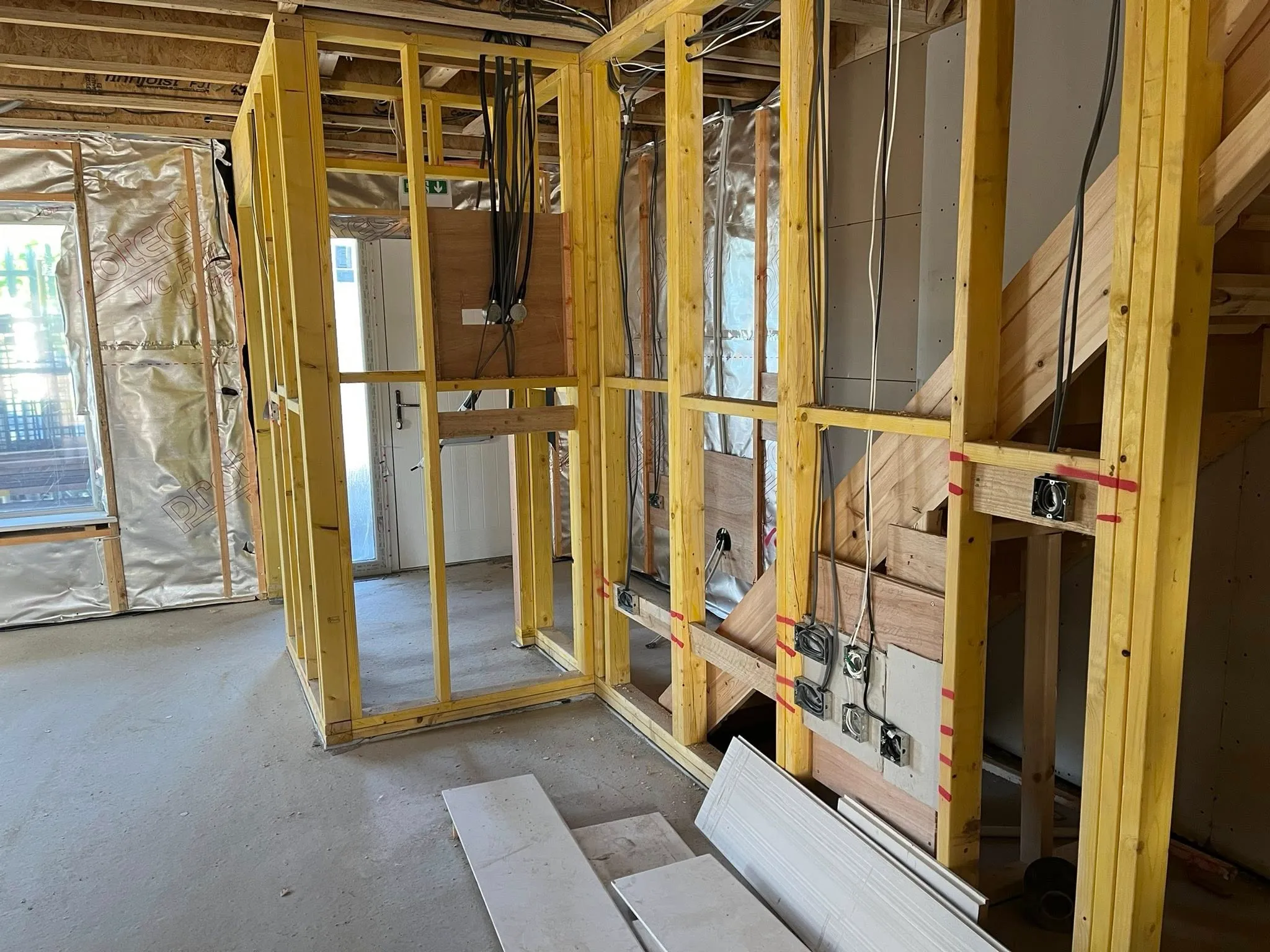 A room that is under construction with a lot of wood.
