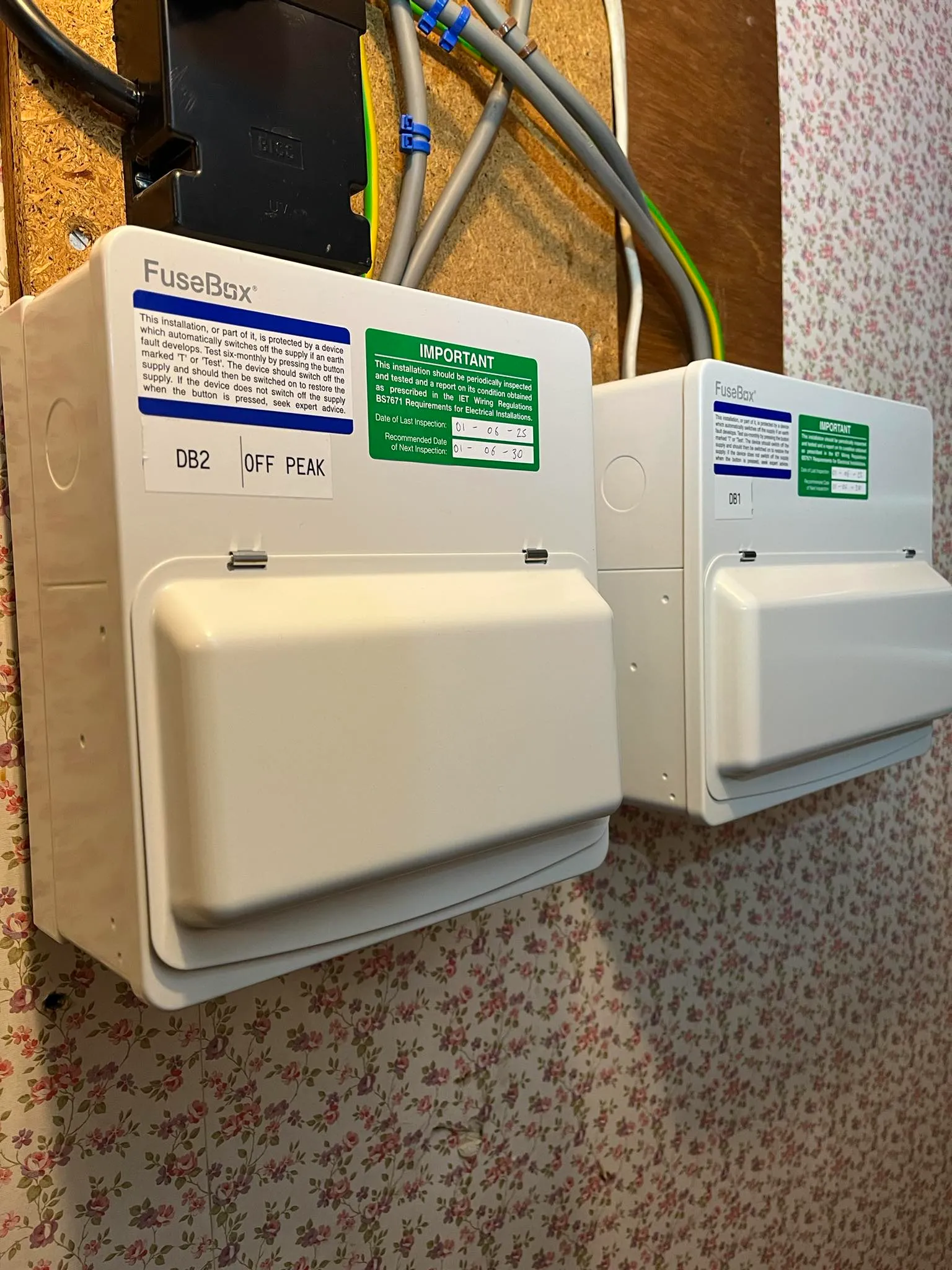 A couple of electrical boxes sitting on a wall.